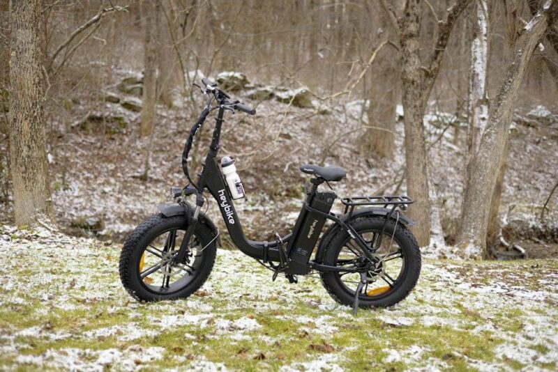 an electric bike parked in a snowy forest